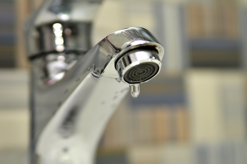 Bathroom tap leaking water drops Bathroom tap leaking water drops
